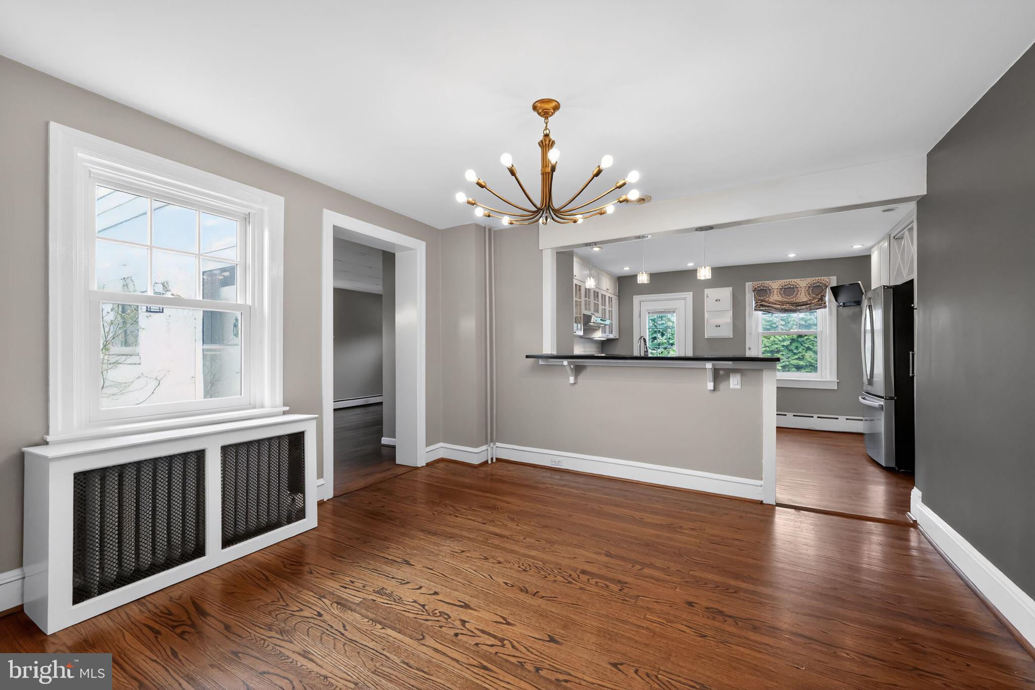 522 Dudley Avenue Narberth, PA 19072 - Photo 14 of 40 a view of a big room with wooden floor and a kitchen