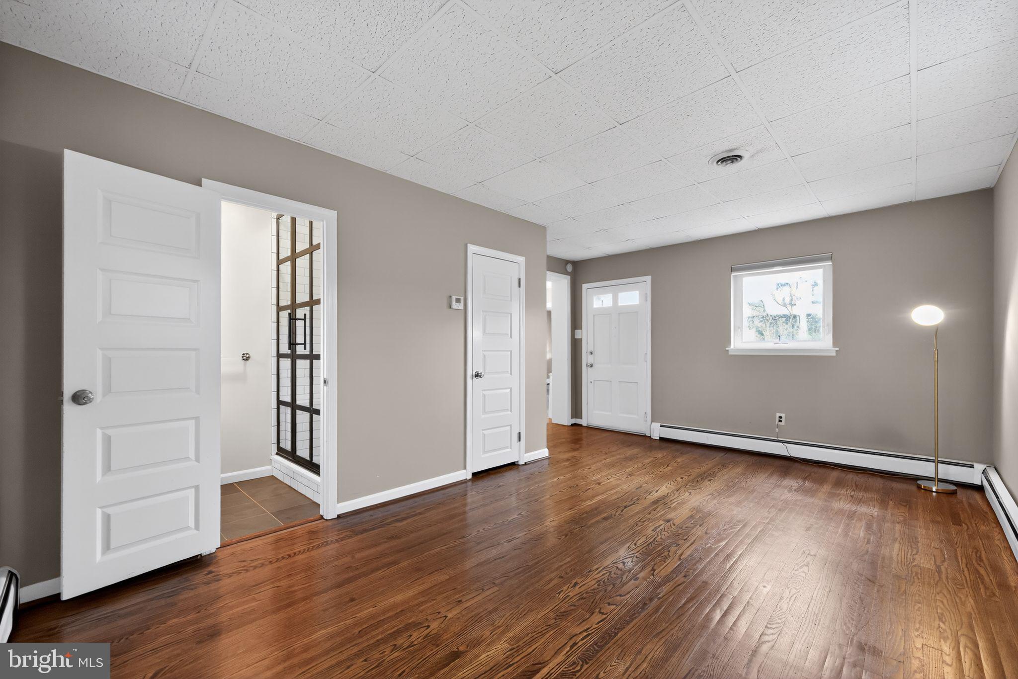 522 Dudley Avenue Narberth, PA 19072 - Photo 17 of 40 an empty room with wooden floor and windows