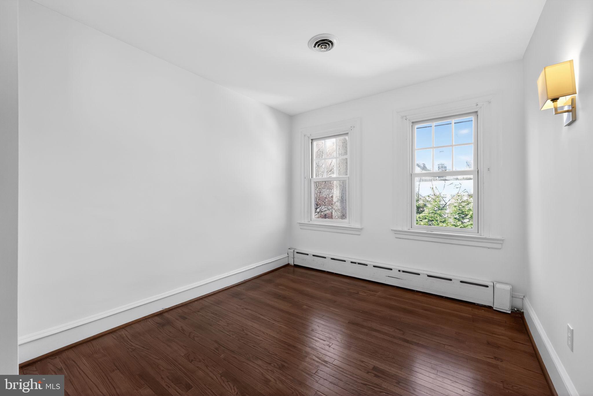 522 Dudley Avenue Narberth, PA 19072 - Photo 30 of 40 an empty room with wooden floor and windows