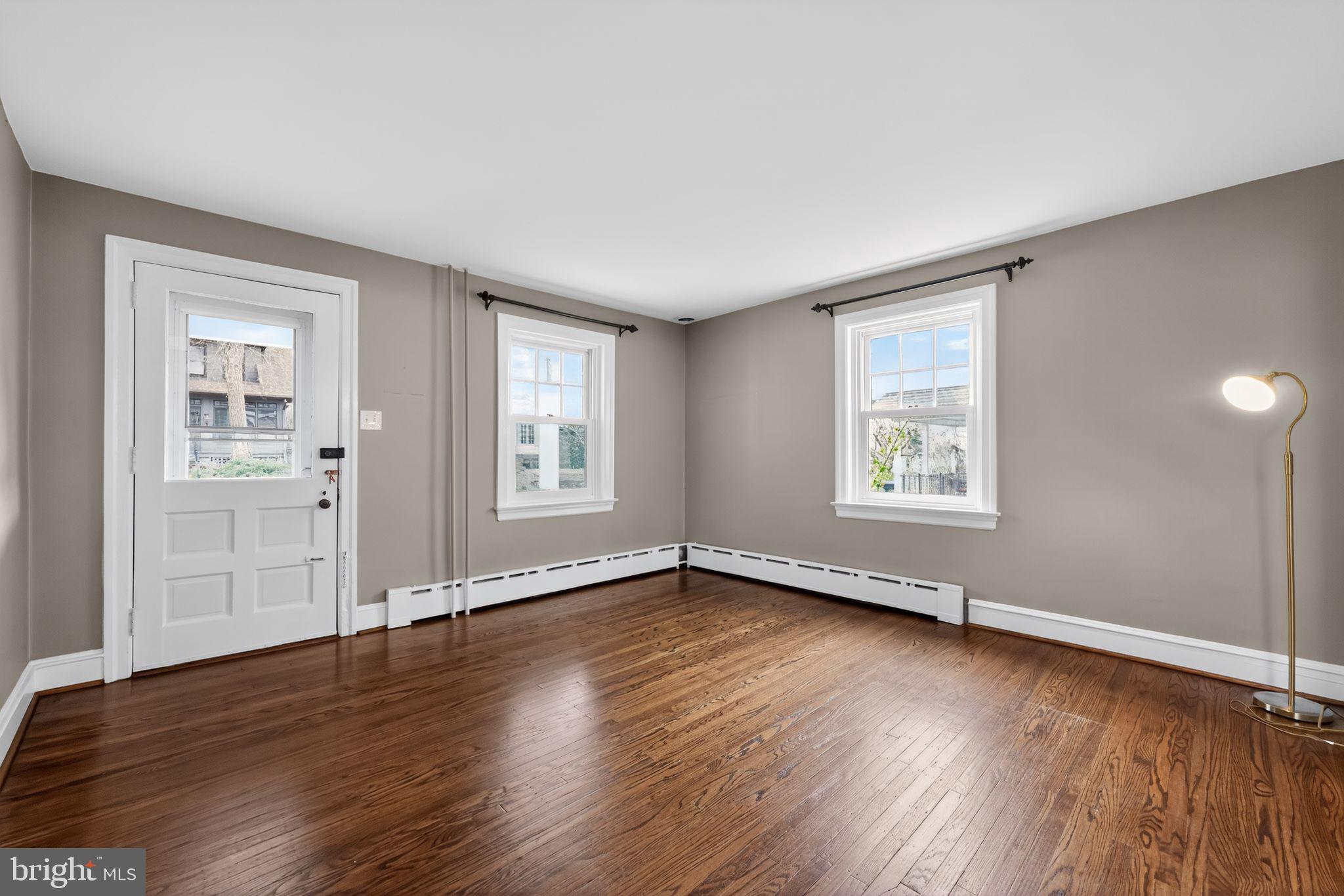 522 Dudley Avenue Narberth, PA 19072 - Photo 8 of 40 an empty room with wooden floor and windows