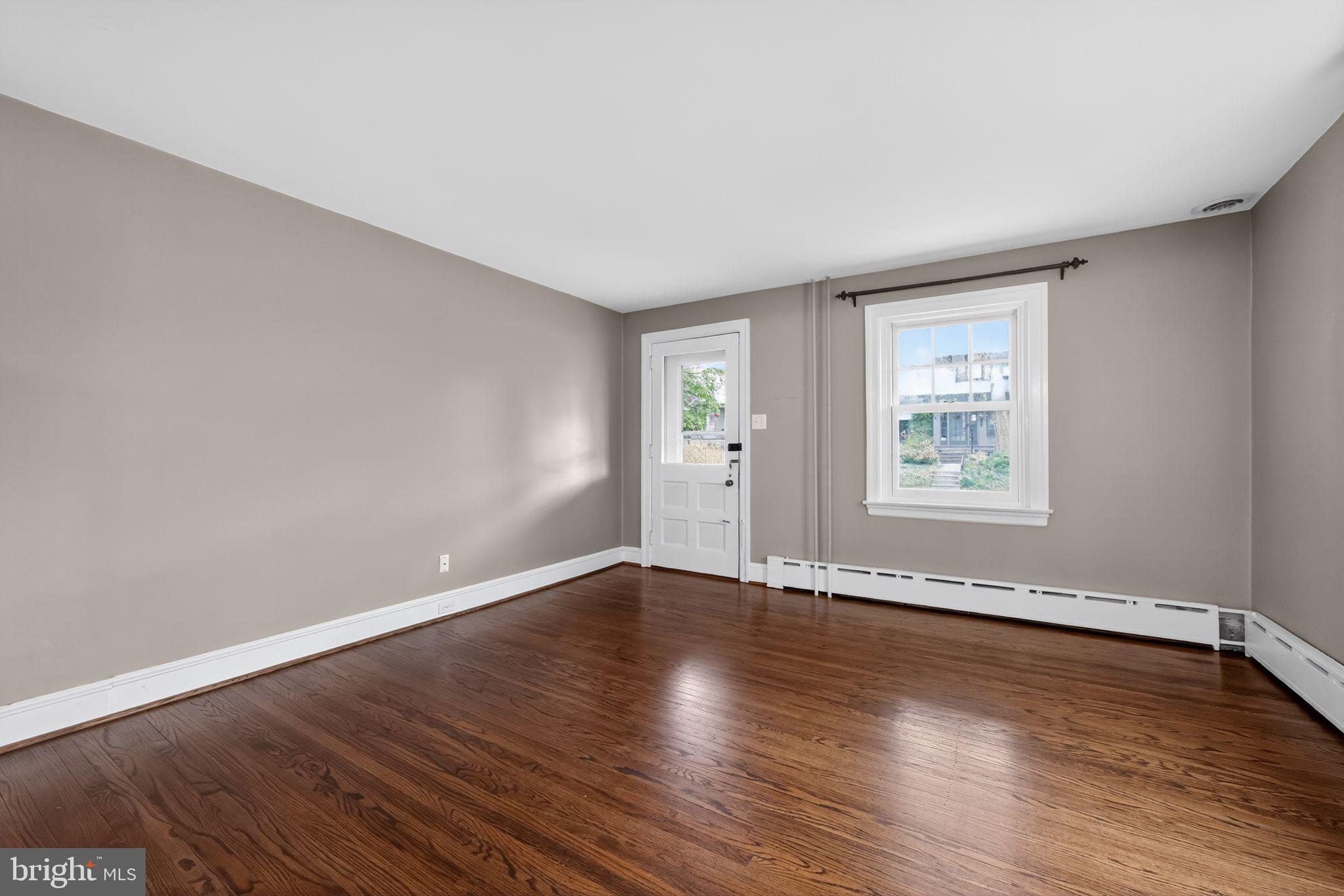 522 Dudley Avenue Narberth, PA 19072 - Photo 10 of 40 a view of an empty room with wooden floor and a window