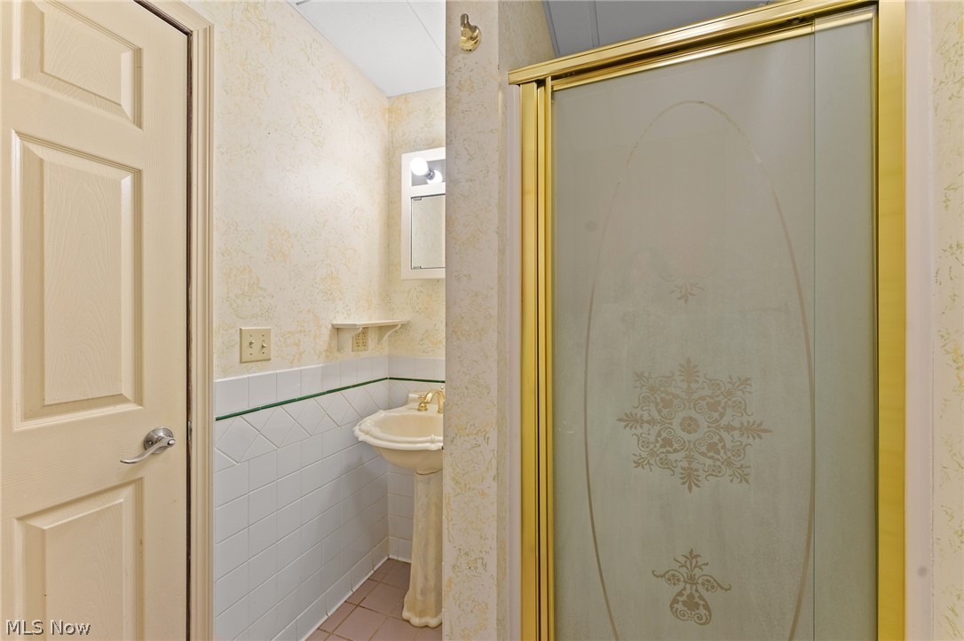 1815 Wick Campbell Road Hubbard, OH 44425 - Photo 34 of 43 Bathroom with a shower with shower door, tile walls, and tile flooring