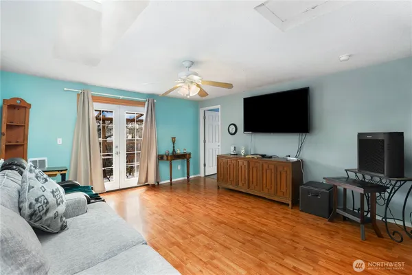 a bedroom with furniture and a flat screen tv