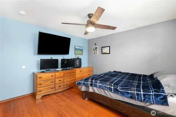 a bedroom with a bed and a flat screen tv