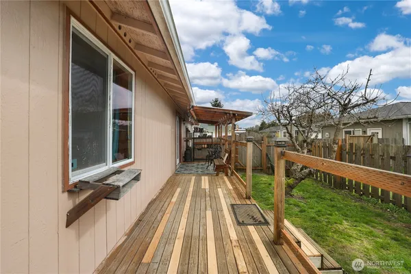 a view of balcony with wooden floor and outdoor seating