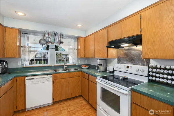 a kitchen with a sink cabinets and window