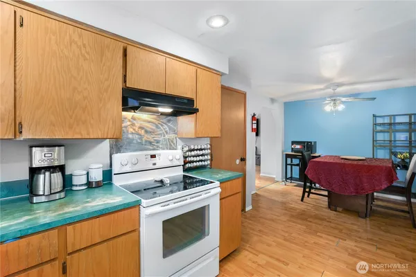 a kitchen with a stove and a refrigerator