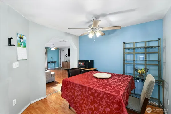 a bedroom with a bed a chandelier and a chair