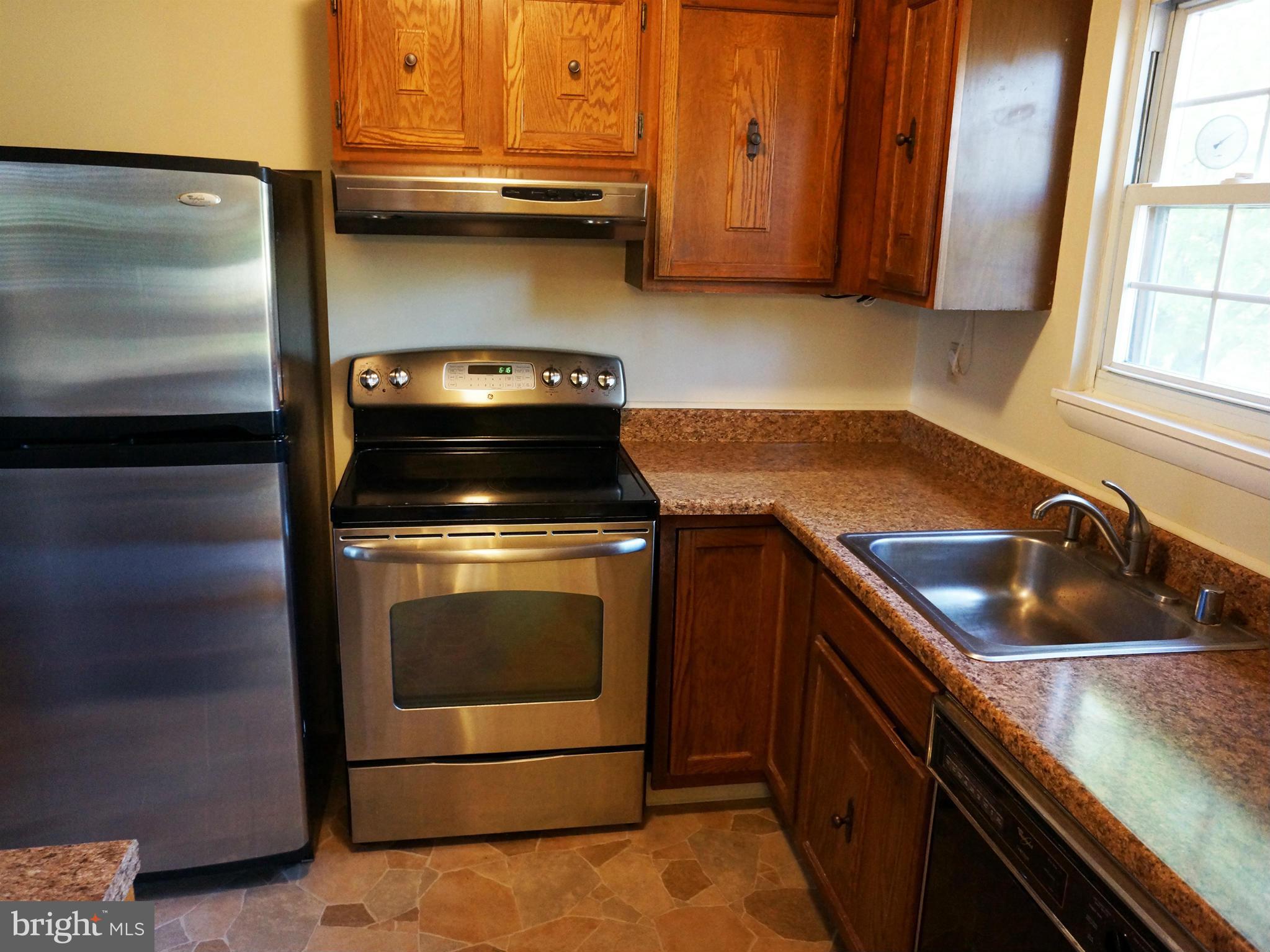 2614 Neudecker Road Westminster, MD 21157 - Photo 15 of 26 a kitchen with granite countertop a sink stove and cabinets