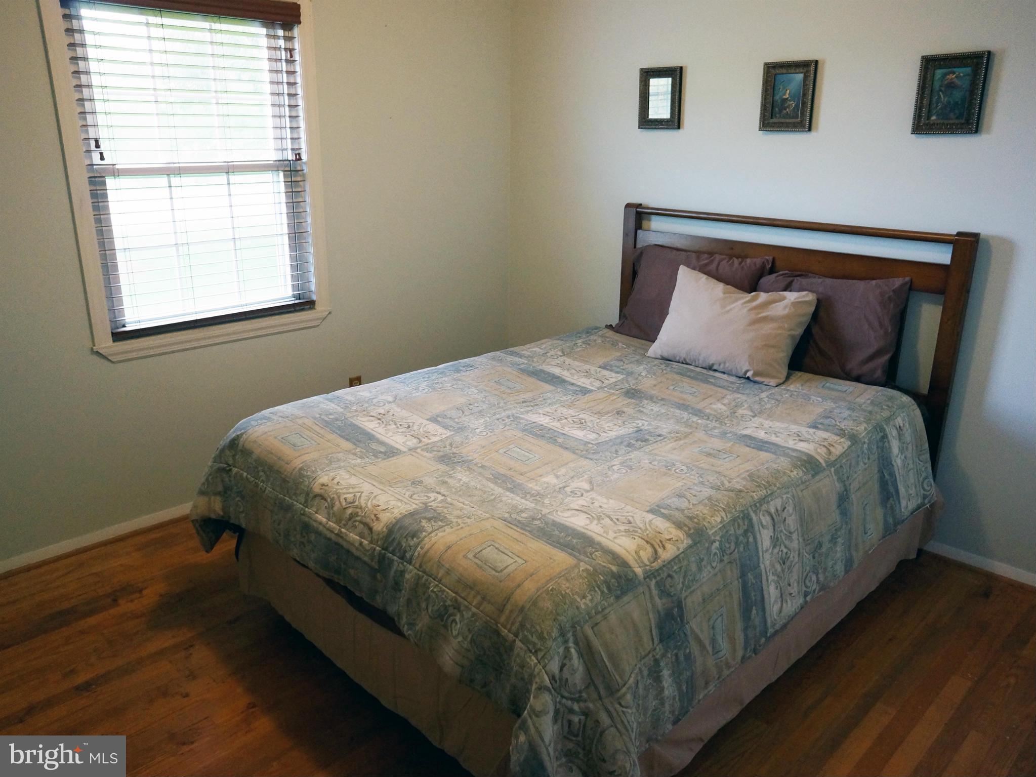 2614 Neudecker Road Westminster, MD 21157 - Photo 19 of 26 a bed sitting in a bedroom next to a window