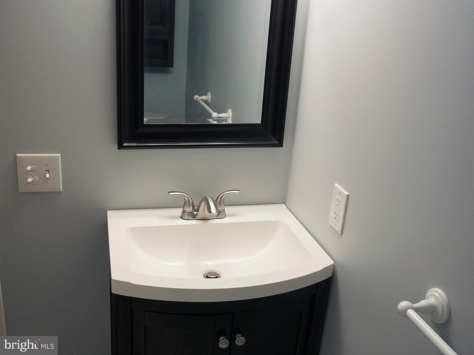 2614 Neudecker Road Westminster, MD 21157 - Photo 24 of 26 a bathroom with a sink and a mirror