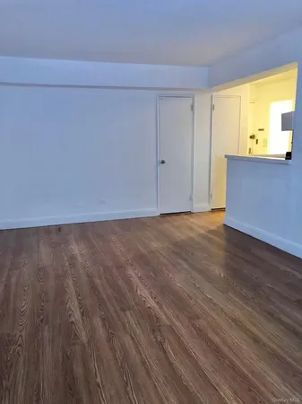 an empty room with windows and city view
