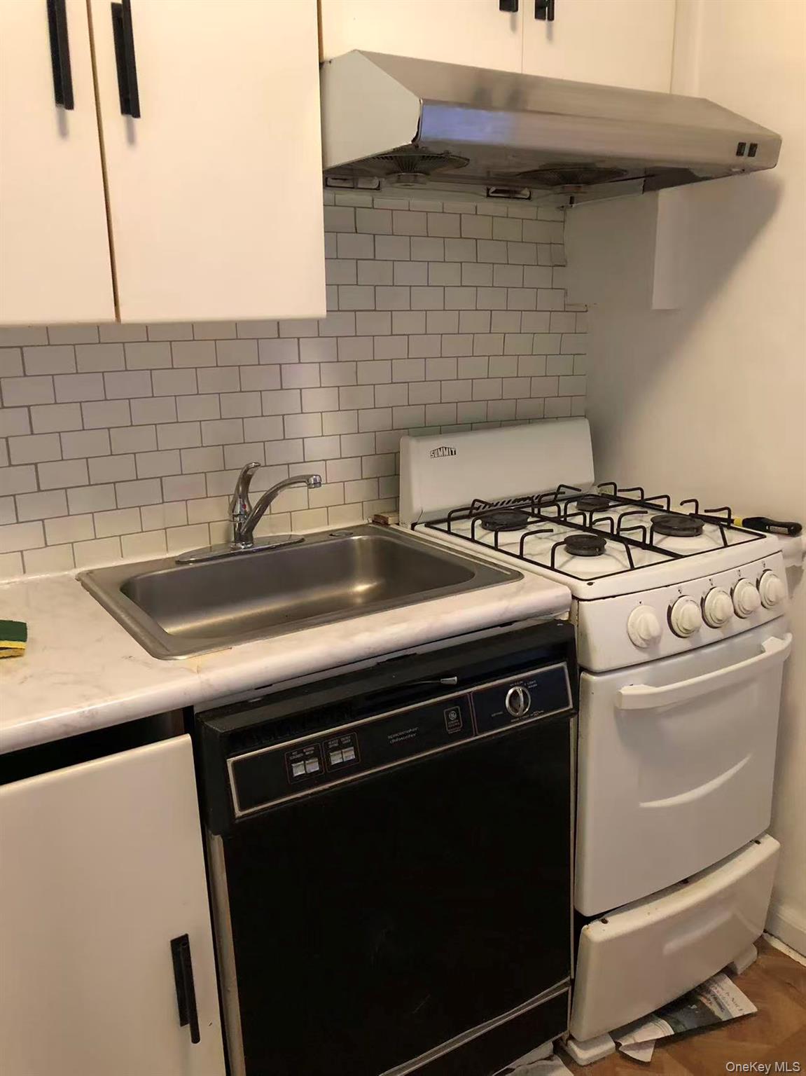 150-25 72nd Road, Unit 1L Queens, NY 11367 - Photo 5 of 12 a kitchen with a stove and a sink