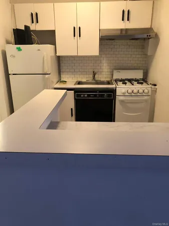 a view of a kitchen with wooden floor and electronic appliances