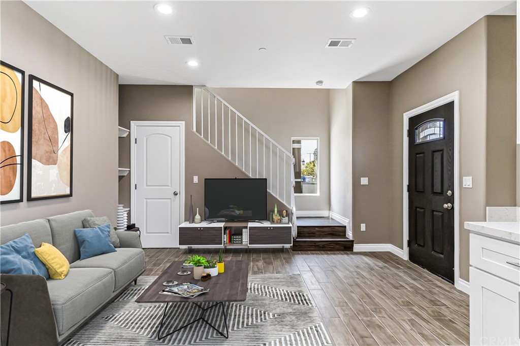 14092 Edwards Street Westminster, CA 92683 - Photo 1 of 1 a living room with furniture a flat screen tv and a fireplace