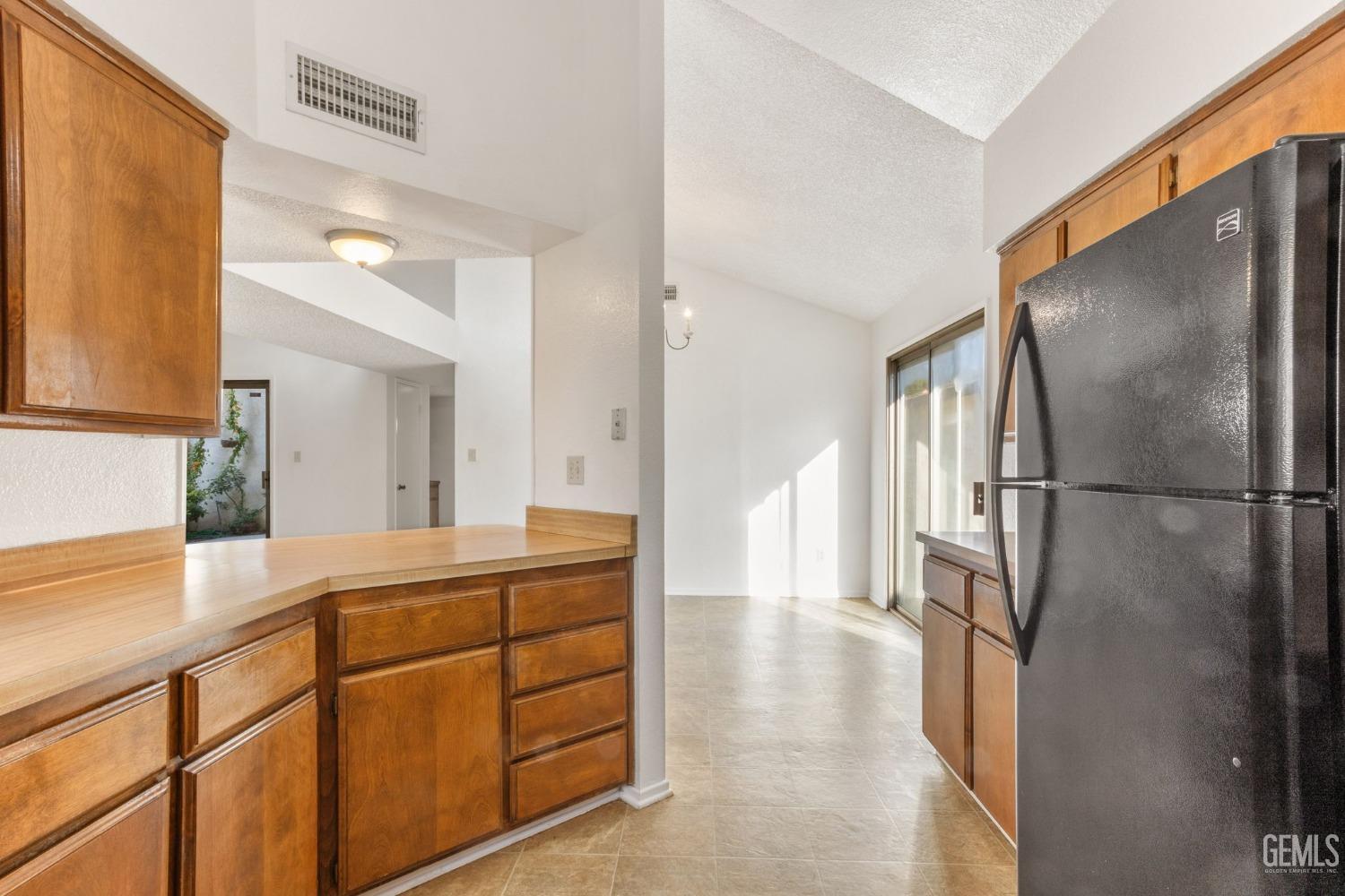 Undisclosed Address Bakersfield, CA 93309 - Photo 11 of 33 a hallway with a refrigerator and a sink