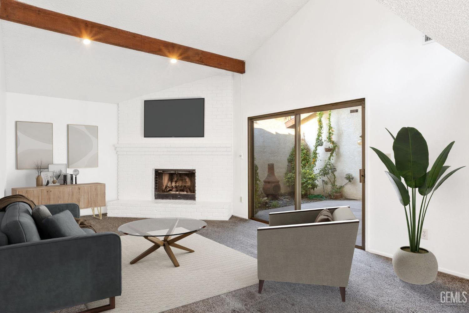 Undisclosed Address Bakersfield, CA 93309 - Photo 13 of 33 a living room with furniture a fireplace and a potted plant