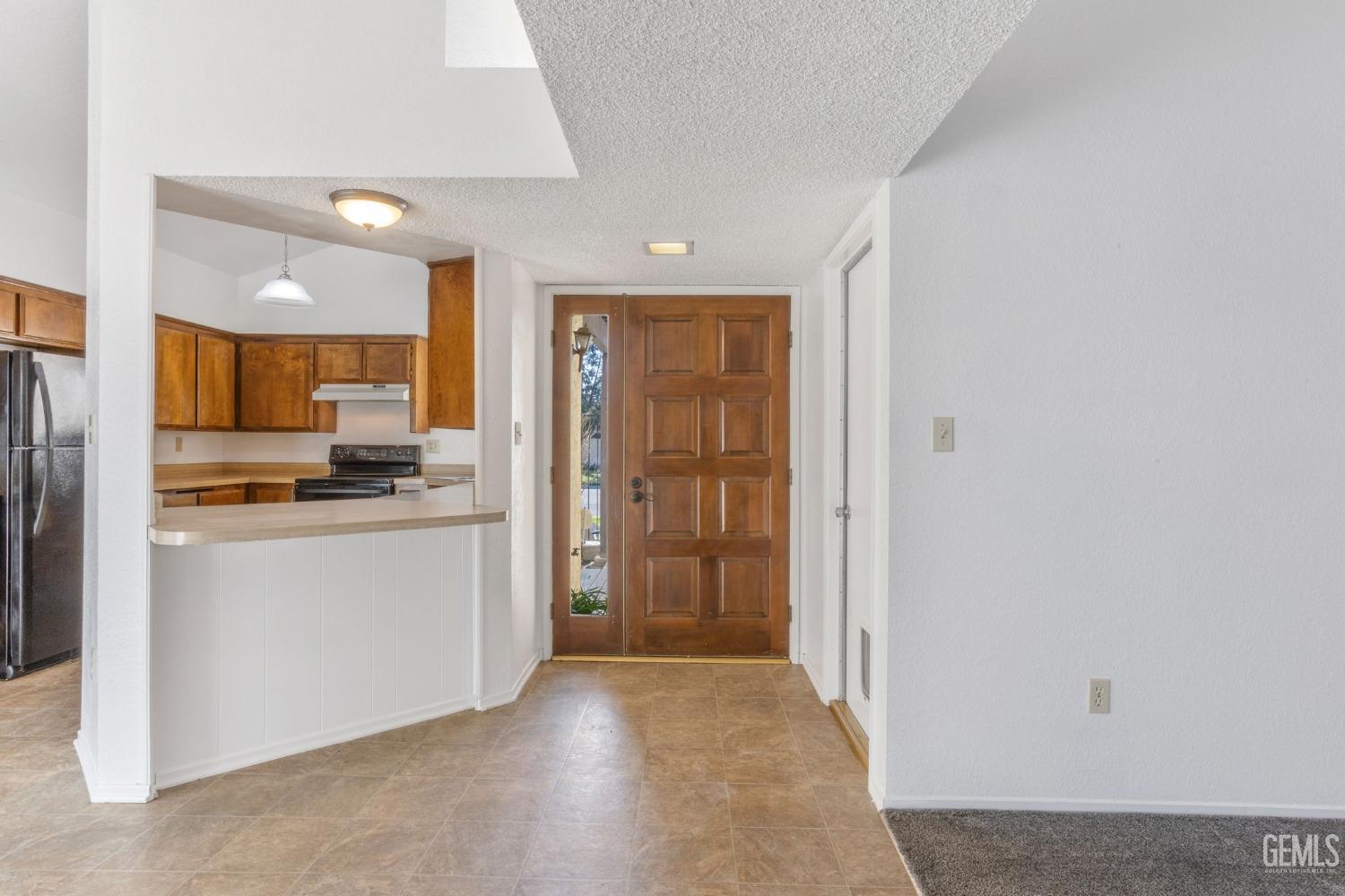 Undisclosed Address Bakersfield, CA 93309 - Photo 4 of 33 a view of a kitchen with refrigerator and wooden floor