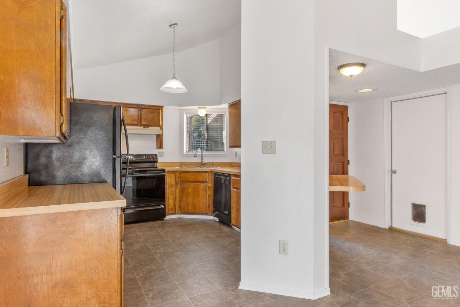 Undisclosed Address Bakersfield, CA 93309 - Photo 7 of 33 a kitchen with a sink a stove and refrigerator
