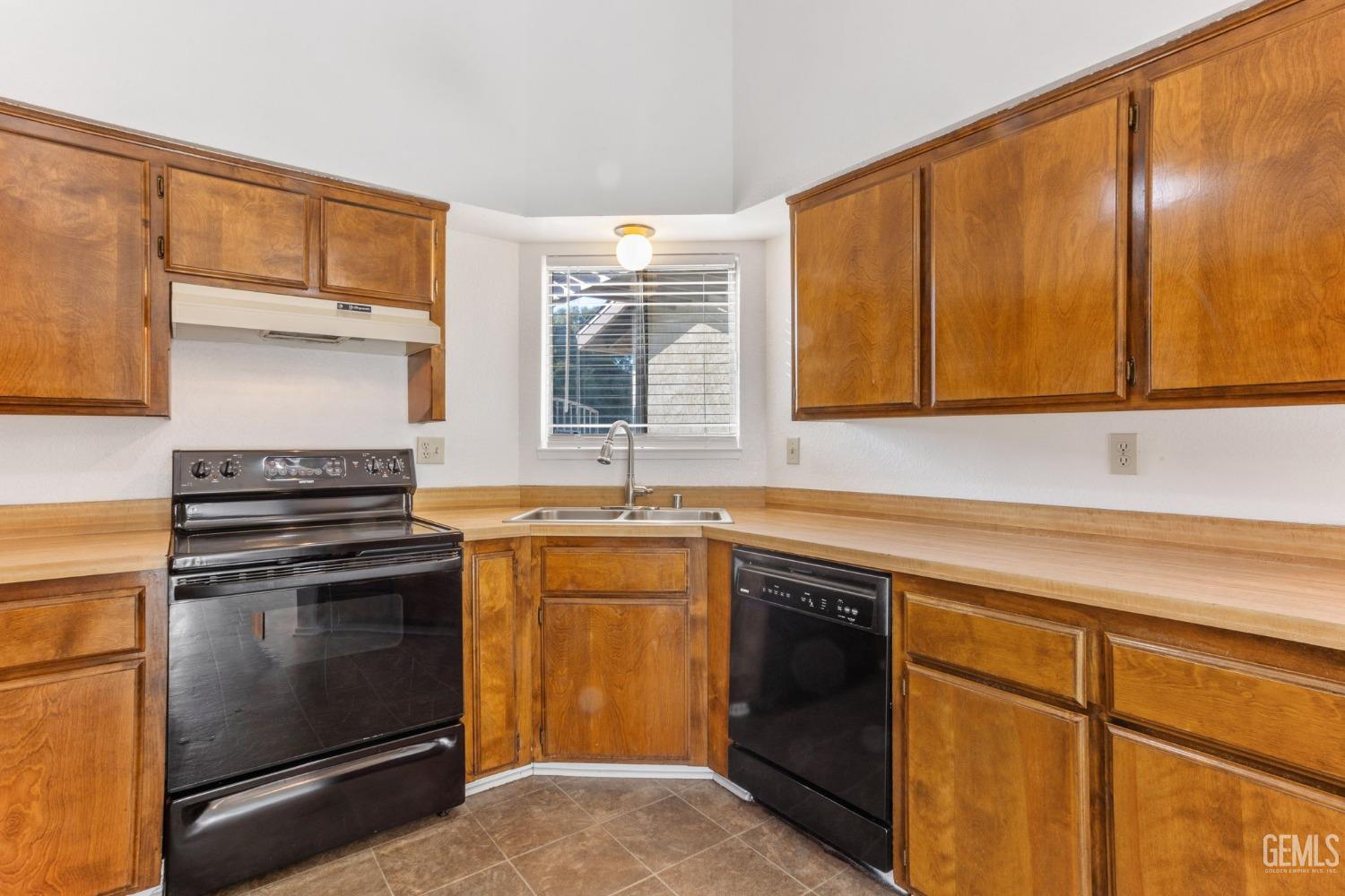 Undisclosed Address Bakersfield, CA 93309 - Photo 9 of 33 a kitchen with a sink stove and cabinets