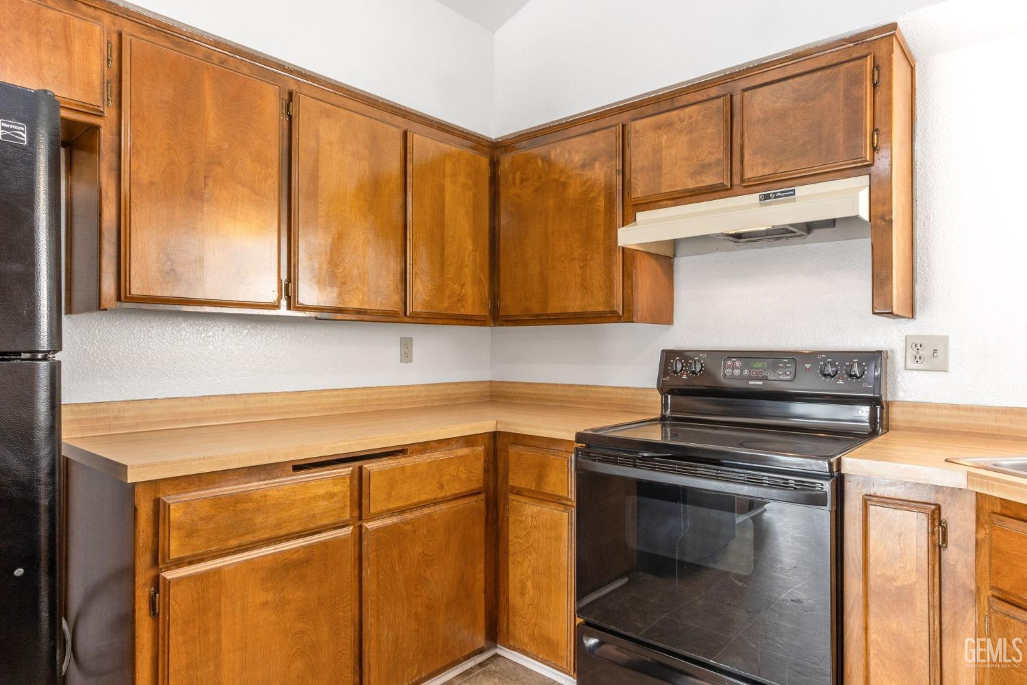 Undisclosed Address Bakersfield, CA 93309 - Photo 10 of 33 a kitchen with a stove and a microwave
