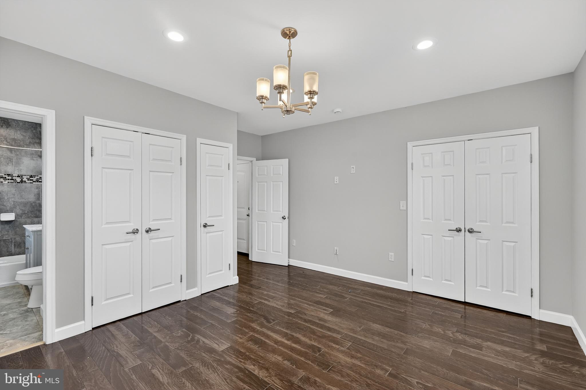 5619 1st Place Northwest, Unit 3 Washington, DC 20011 - Photo 17 of 23 a view of an empty room with chandelier and a kitchen