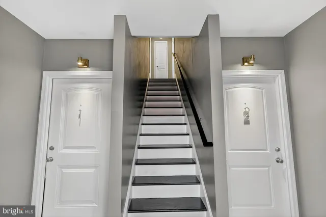 a view of entryway and hall with wooden floor