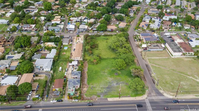 an aerial view of residential houses with yard