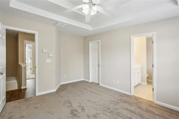 an empty room with fan and entrance