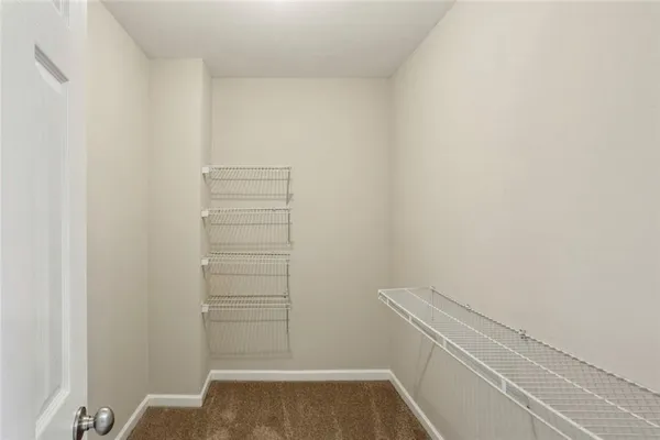 a view of walk in closet with clothes
