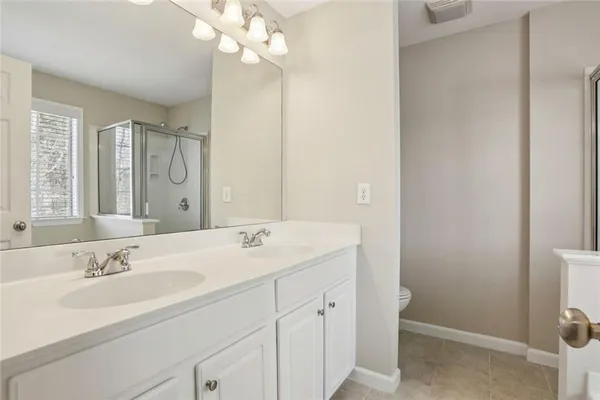a bathroom with a sink a mirror and a shower