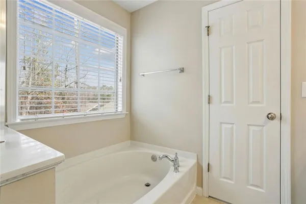 a white bath tub sitting next to a window