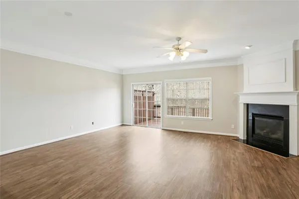 a view of an empty room with a window and fireplace