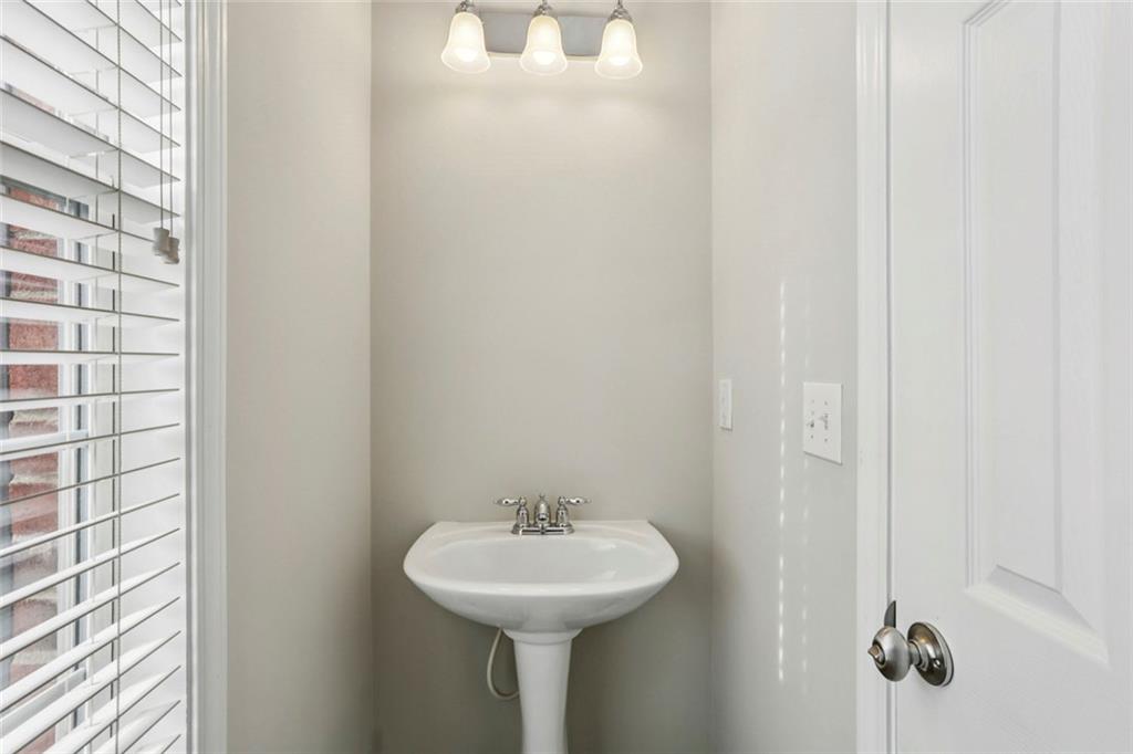 642 Bernay Way Atlanta, GA 30350 - Photo 8 of 20 a bathroom with a sink and a mirror