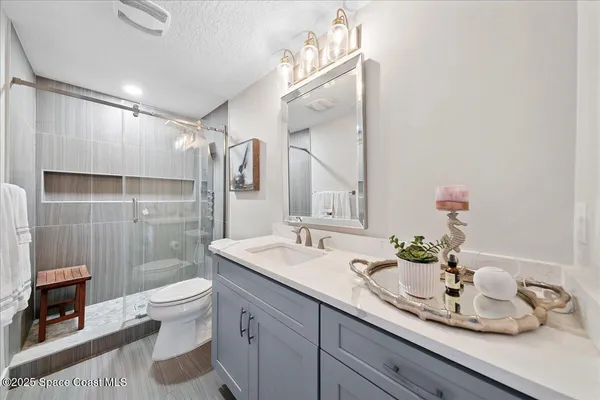 a bathroom with a double vanity sink toilet and shower