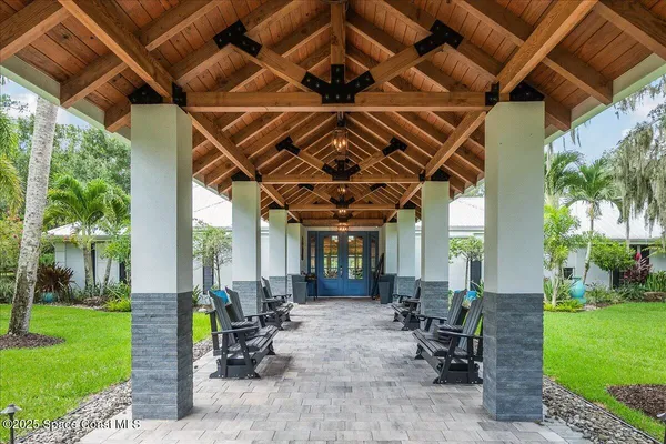 a view of a porch with furniture and garden