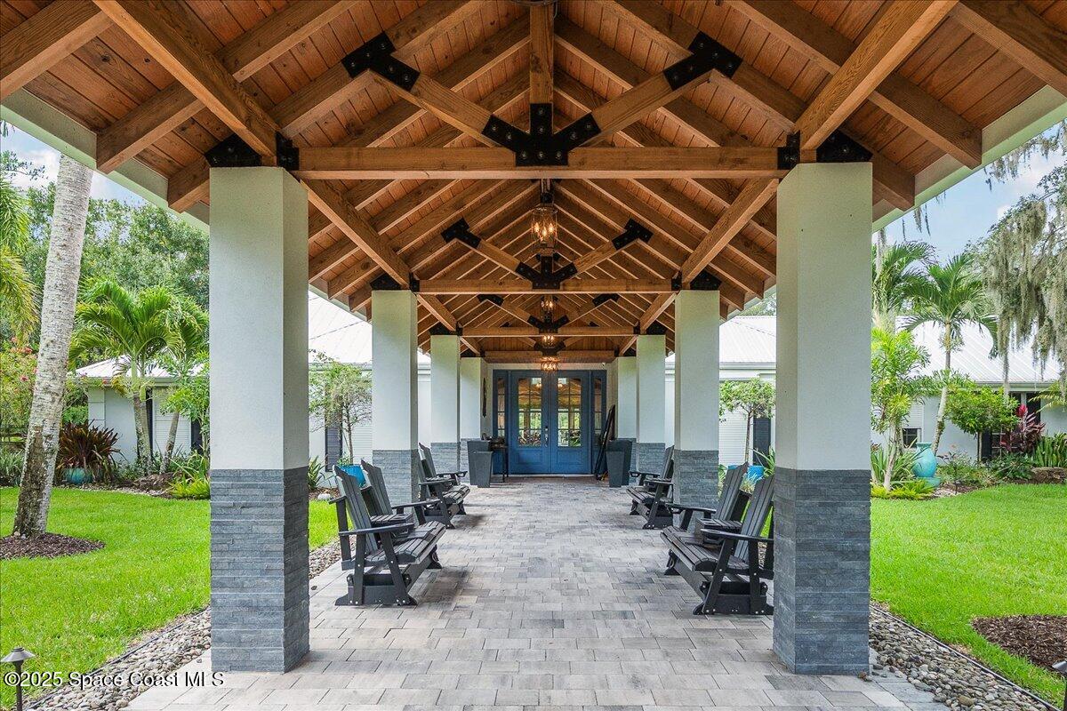 5685 Lake Washington Road Melbourne, FL 32934 - Photo 3 of 62 a view of a porch with furniture and garden