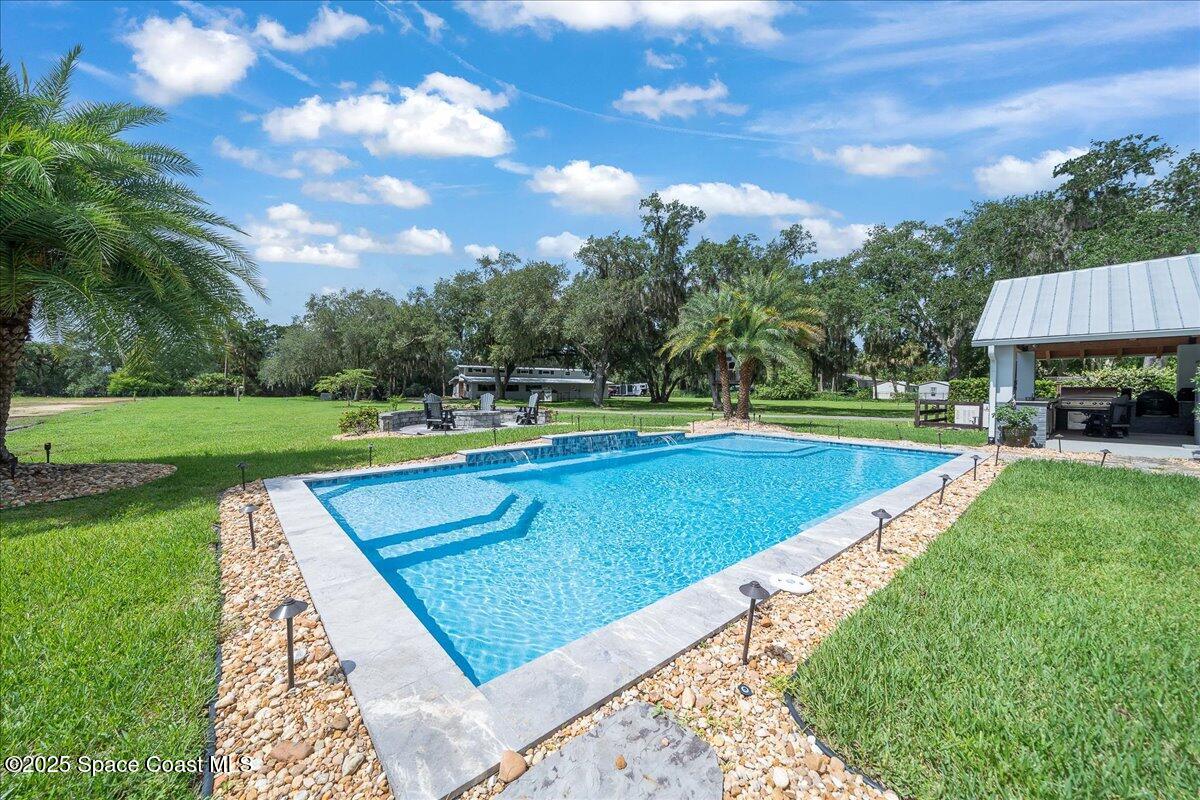 5685 Lake Washington Road Melbourne, FL 32934 - Photo 31 of 62 a view of a swimming pool and a yard