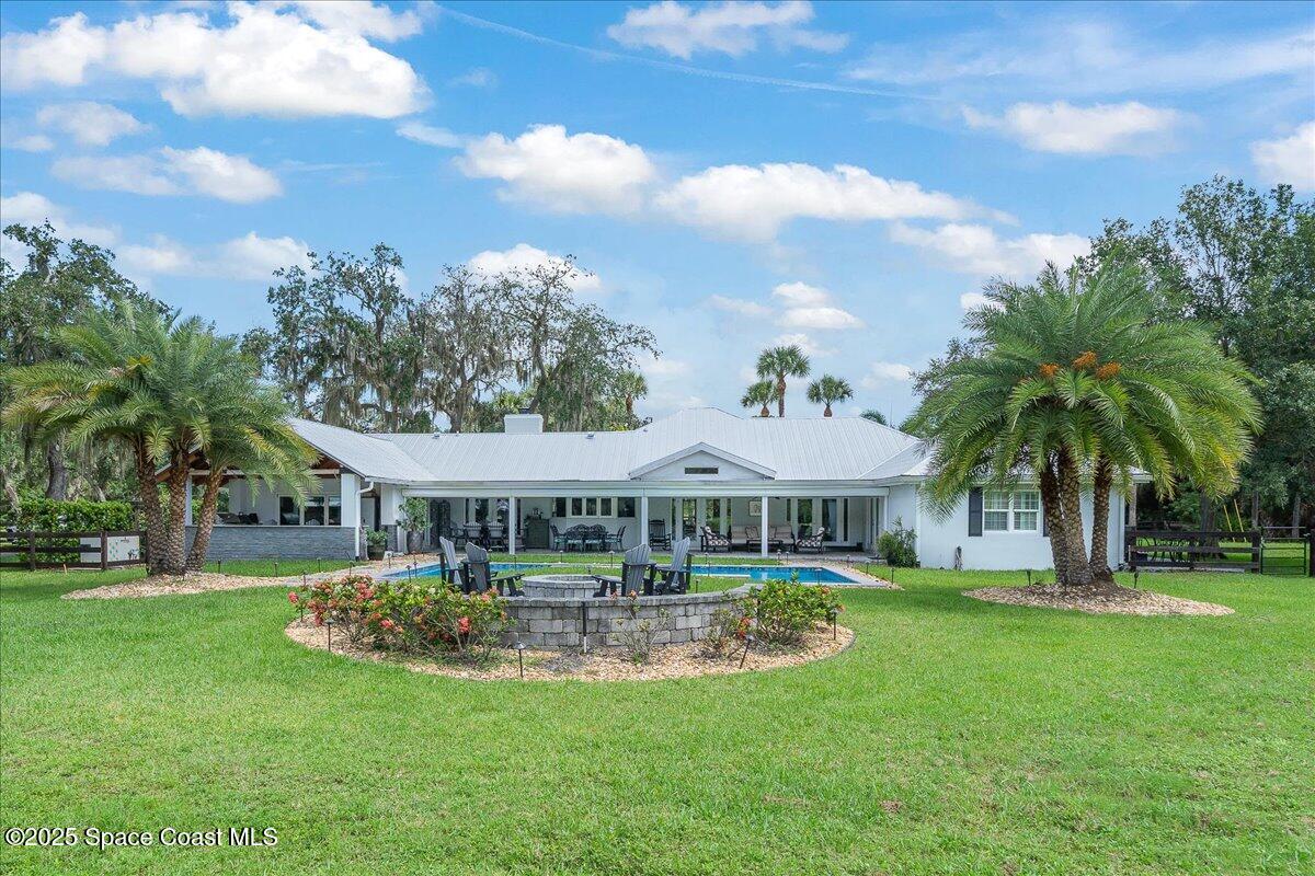 5685 Lake Washington Road Melbourne, FL 32934 - Photo 36 of 62 a view of a house with swimming pool and porch with furniture