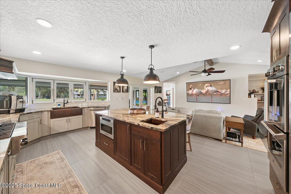 5685 Lake Washington Road Melbourne, FL 32934 - Photo 9 of 62 a kitchen with stainless steel appliances granite countertop a stove and a wooden floors