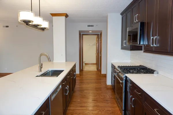 a kitchen with granite countertop a stove and a microwave oven
