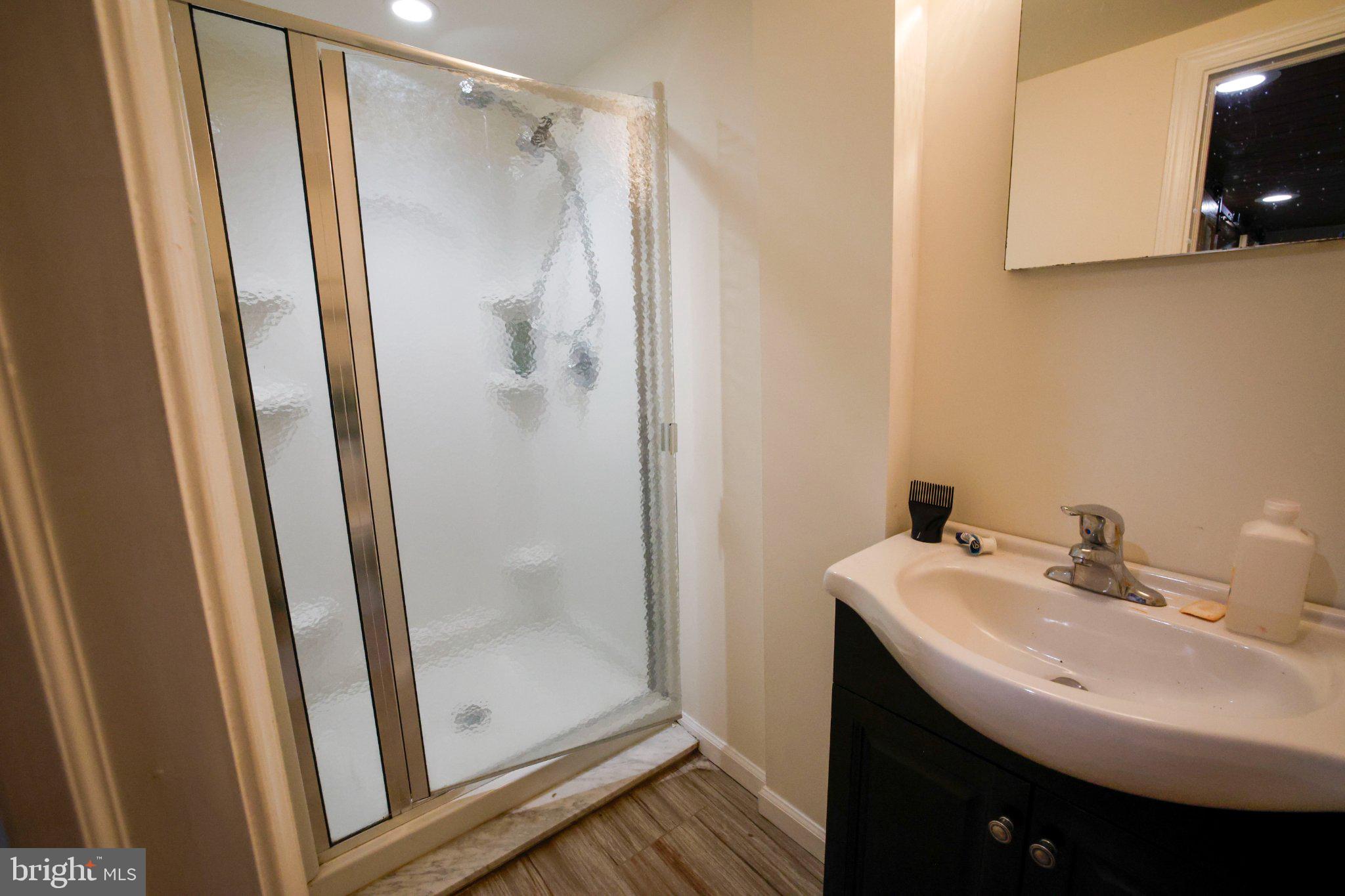 25 Keller Road Cochranville, PA 19330 - Photo 13 of 58 a bathroom with a sink a mirror and shower