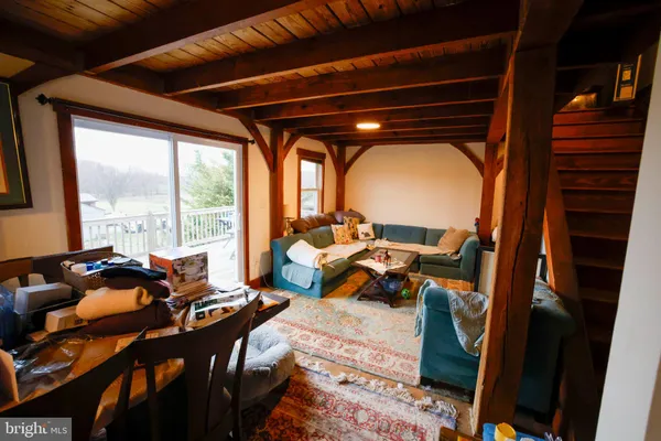a bedroom with furniture and a large window
