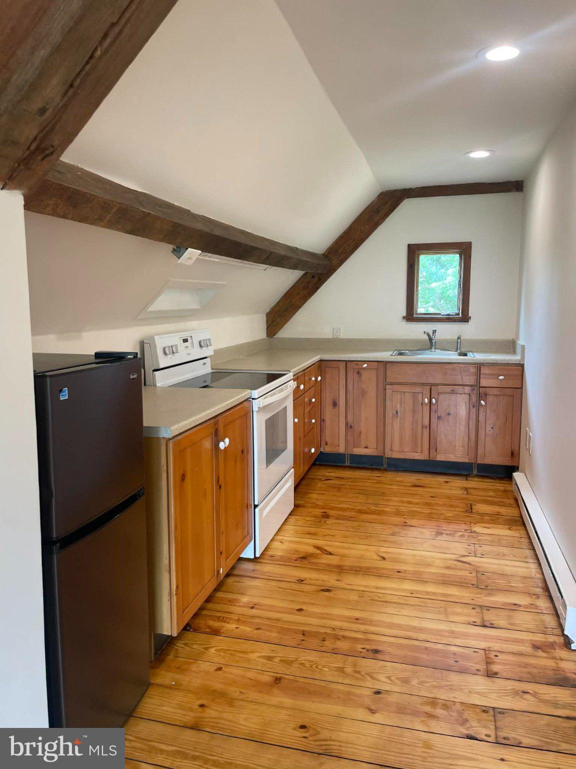 25 Keller Road Cochranville, PA 19330 - Photo 3 of 15 a view of a kitchen with stainless steel appliances wooden floor and cabinets