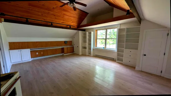 a living room with furniture and a lamp