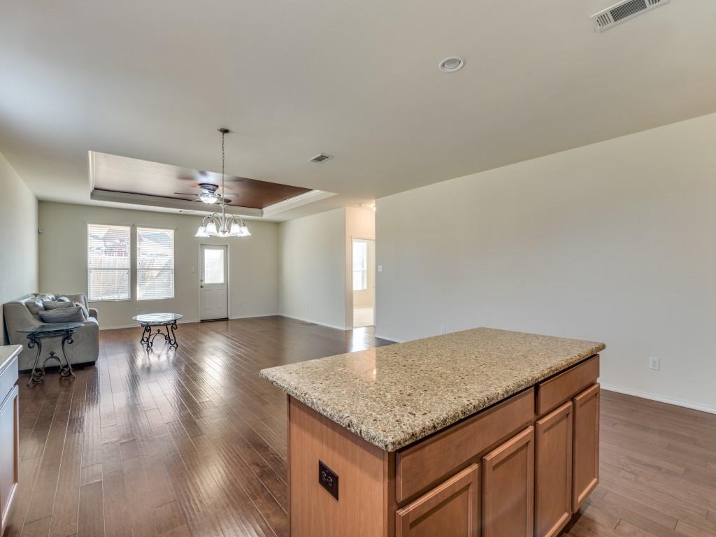 2232 Heaton Street Forney, TX 75126 - Photo 11 of 34 a kitchen with kitchen island granite countertop a stove and a wooden floor