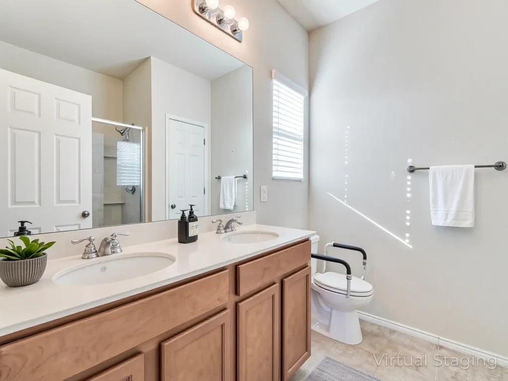 2232 Heaton Street Forney, TX 75126 - Photo 19 of 34 a bathroom with a sink toilet and vanity