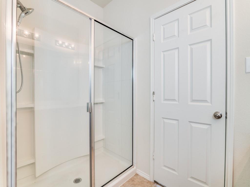 2232 Heaton Street Forney, TX 75126 - Photo 21 of 34 a bathroom with a glass shower door