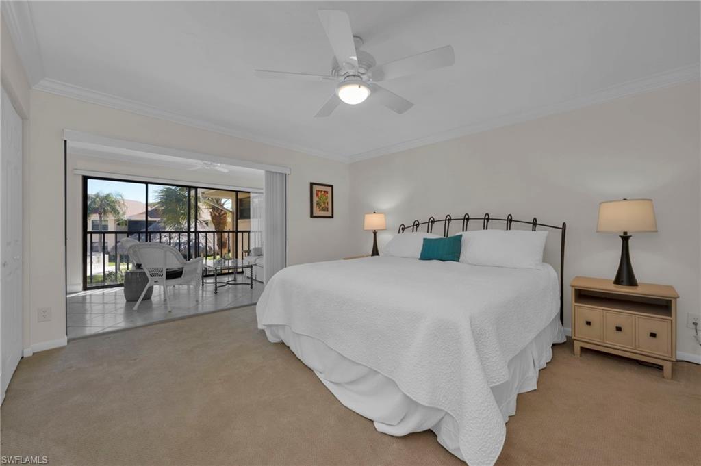 1100 9th Street South, Unit D201 Naples, FL 34102 - Photo 11 of 25 a bedroom with a bed and a large window