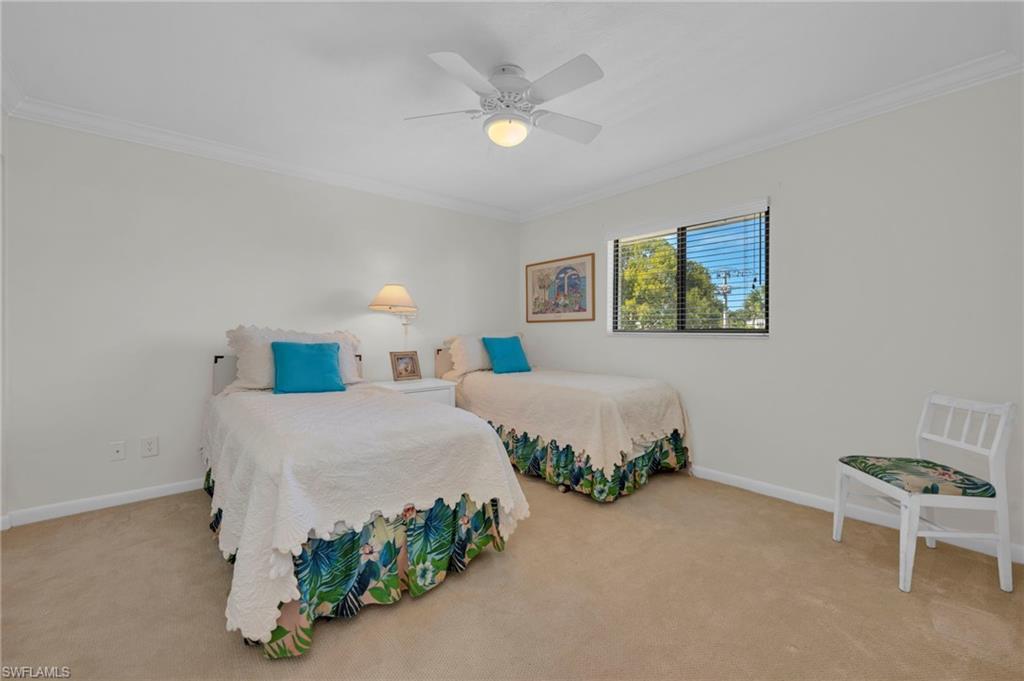1100 9th Street South, Unit D201 Naples, FL 34102 - Photo 15 of 25 a bedroom with a bed and painting on the wall